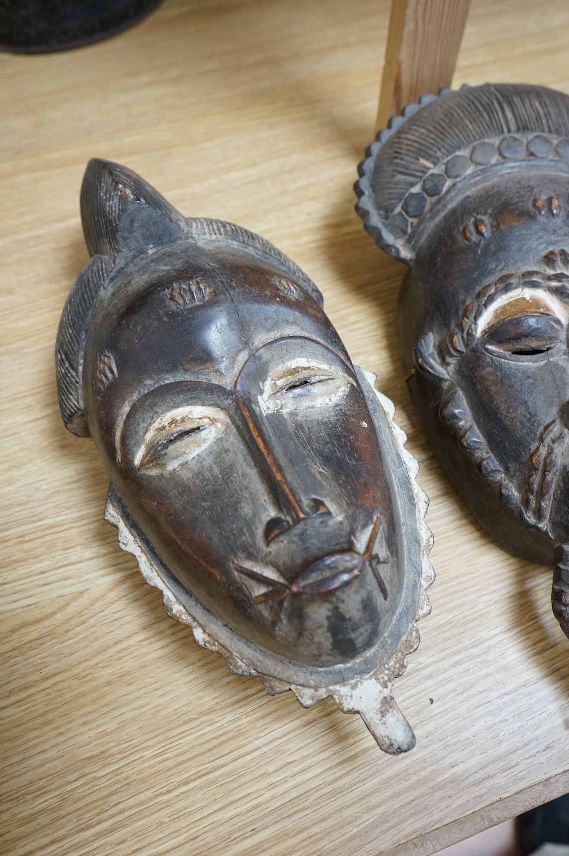 Three African carved hardwood masks, largest 39cm high. Condition - fair